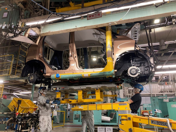 Workers install a battery for a new electric vehicle model at Mitsubishi Motor Corp's factory in Kurashiki, Japan May 19, 2022. Picture taken May 19, 2022. 