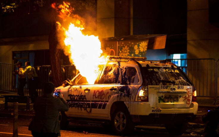 A police vehicle partially burns during a protest against President Guillermo Lasso's economic and environmental policies and in support of Indigenous leader Leonidas Iza and other demonstrators arrested, in Quito, Ecuador, June 14, 2022. 