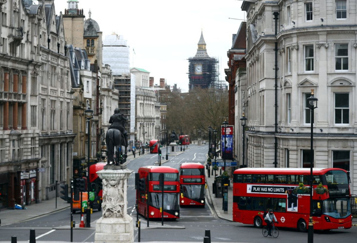 London buses travel along Whitehall in Westminster in London, Britain, April 2, 2021.