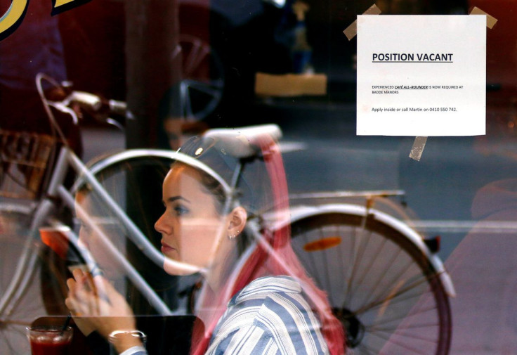 Customers at a local cafe are seen through a window displaying a job vacancy notice in central Sydney, Australia, May 9, 2016. Picture taken May 9, 2016.