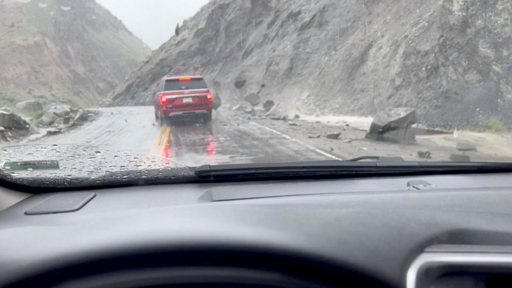 A view shows rocks sliding down the side of a hill and hitting a car at the North Entrance of Yellowstone National Park in Gardiner, Montana, U.S. June 12, 2022 in this still image obtained from a social media video released on June 14, 2022. Anne Leppold