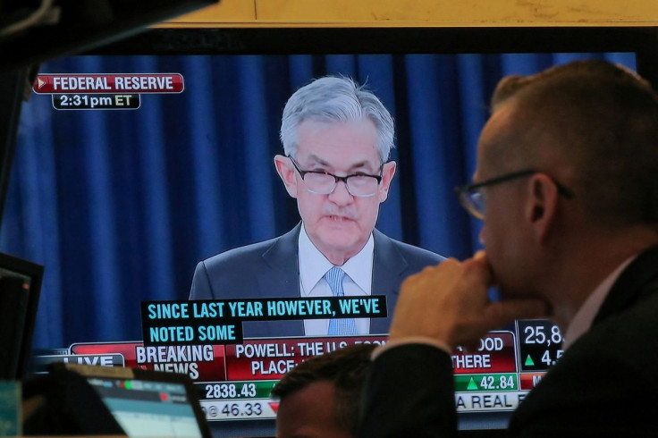 A trader watches U.S. Federal Reserve Chairman Jerome Powell on a screen during a news conference following the two-day Federal Open Market Committee (FOMC) policy meeting, on the floor at the New York Stock Exchange (NYSE) in New York, U.S., March 20, 20
