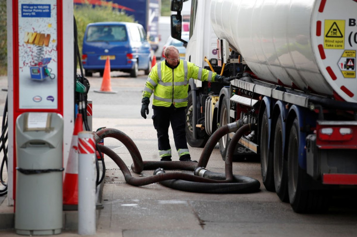 A delivery driver refills the pumps at an Esso petrol station amid fuel shortage in Flamstead, St Albans, Britain, September 29, 2021.