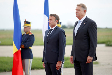 French President Emmanuel Macron and Romanian President Klaus Iohannis stand for the national anthem during a welcome ceremony ahead of their meeting at the Mihail Kogalniceanu Air Base, near the city of Constanta, Romania  June 15, 2022. Yoan Valat/Pool 
