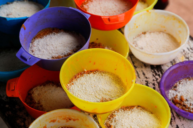 Plastic lunch bowls are refilled with food at the Kyerekrom DA primary school as the Food For All Africa organization delivers food supplies to schools in vulnerable communities in Kyerekrom, Ashanti Region, Ghana June 7, 2022. Picture taken June 7, 2022.