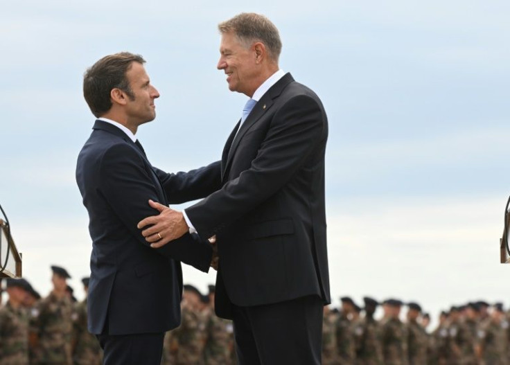 'At the gates of our European'Union, an unprecedented geopolitical situation is playing out," Macron, seen here greeting Romanian President Klaus Iohannis (r), said after meeting French troops stationed in Romania