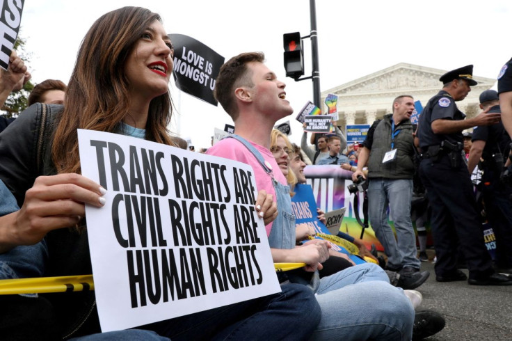 LGBTQ activists and supporters block the street outside the U.S. Supreme Court as it hears arguments in a major LGBT rights case on whether a federal anti-discrimination law that prohibits workplace discrimination on the basis of sex covers gay and transg