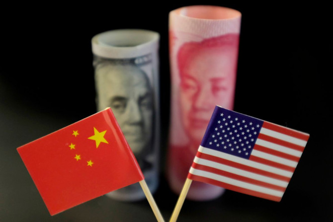 U.S. and Chinese flags are seen in front of a U.S. dollar banknote featuring American founding father Benjamin Franklin and a China's yuan banknote featuring late Chinese chairman Mao Zedong in this illustration picture taken May 20, 2019. 