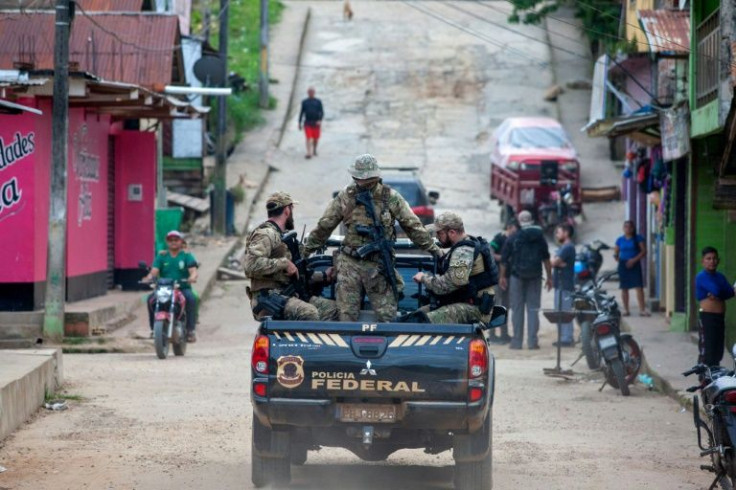 Federal police experts travel by pick-up truck on June 14, 2022 after arriving at the port of Atalaia do Norte, in Amazonas state, Brazil