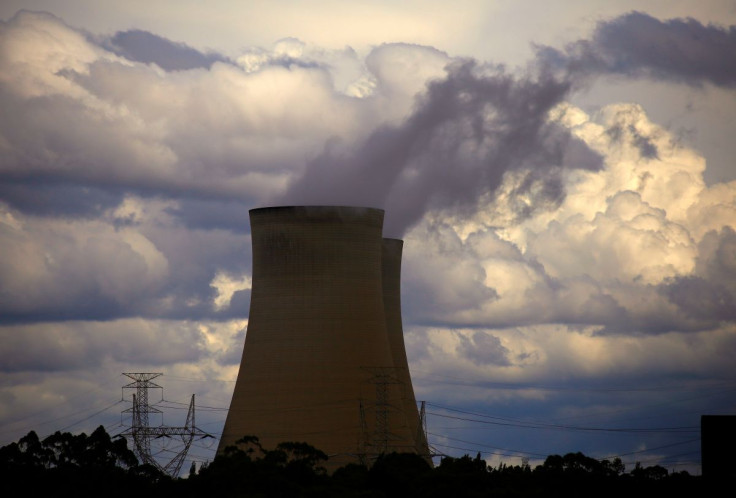 Storm clouds can be seen behind chimneys at the Bayswater coal-powered thermal power station located near the central New South Wales town of Muswellbrook, Australia, March 14, 2017. Picture taken Mach 14, 2017.     