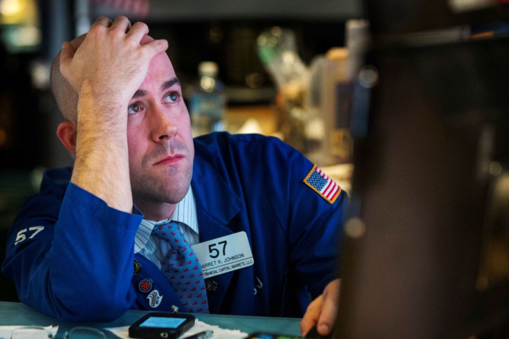 A trader watches the screen at his terminal on the floor of the New York Stock Exchange in New York October 15, 2014. 