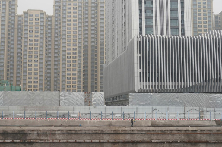 A labouer walks at a construction site in Beijing, China July 20, 2017. Picture taken July 20, 2017.