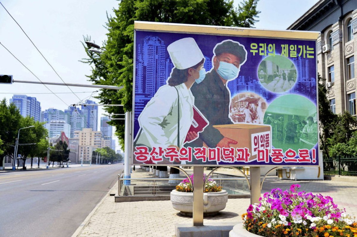 A sign depicting a scene of medical products transportation is displayed at the empty street, amid growing fears over the spread of coronavirus disease (COVID-19), in Pyongyang, North Korea, in this photo released by Kyodo on May 23, 2022. Kyodo via REUTE