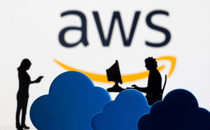 3D printed clouds and figurines are seen in front of the AWS (Amazon Web Service) cloud service logo in this illustration taken February 8, 2022. 