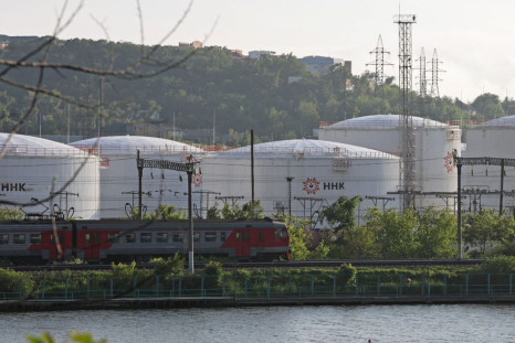 A train moves past oil tanks of the NNK-Primornefteproduct petroleum depot in the far eastern port of Vladivostok, Russia June 11, 2022. 