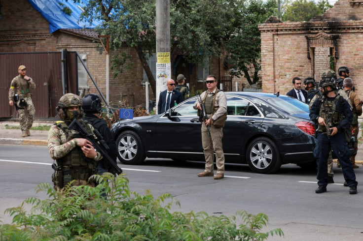 A car is guarded during a visit by Italian Prime Minister Mario Draghi, French President Emmanuel Macron, German Chancellor Olaf Scholz, and Romanian President Klaus Iohannis to Irpin, as Russia's attack on Ukraine continues, near Kyiv, Ukraine June 16, 2