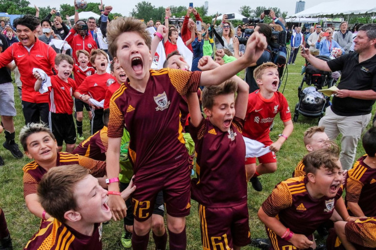 Children and people react as they attend the 2026 FIFA World Cup Host City Selection Watch Party at the Liberty State Park in Jersey City, New Jersey, U.S., June 16, 2022.