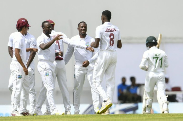 On top: Kemar Roach and Nkrumah Bonner of West Indies celebrate with teammate Alzarri Joseph after the dismissal of Mahmudul Hasan