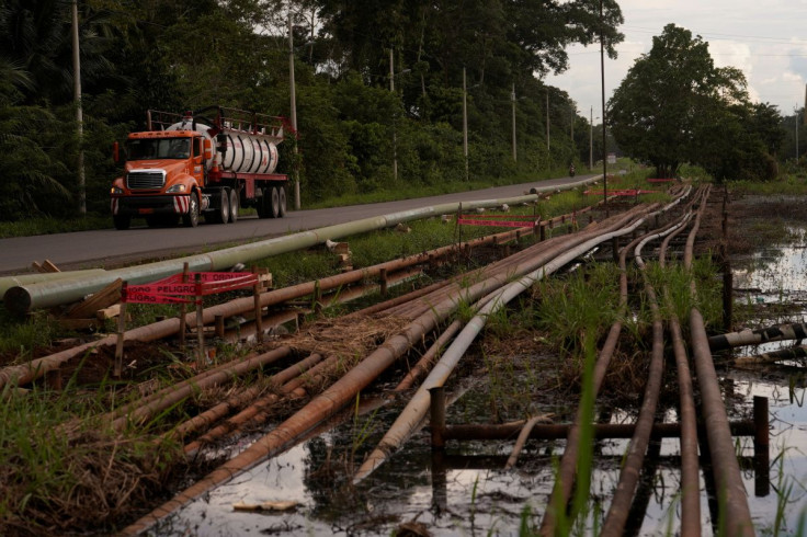 Oil and gas pipelines are pictured on the side of a road near a state-owned oil company Petroecuado's plant in Lago Agrio, Ecuador May 3, 2022. Picture taken May 3, 2022.