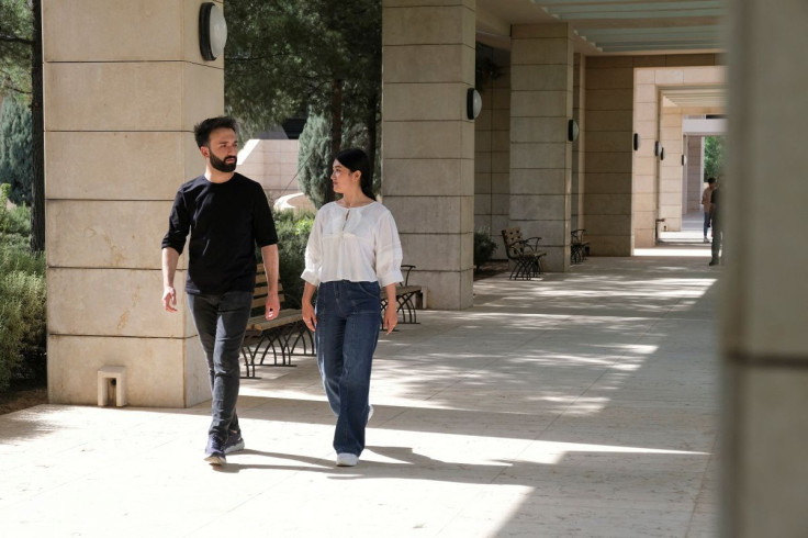Shakila Mohammadi and Esmatullah Sahak walk at the campus of the American University in Sulaimaniya, while both of them left Afghanistan to finish their studies, Sulaimaniya, Iraq, June 14, 2022. Picture taken June 14, 2022.