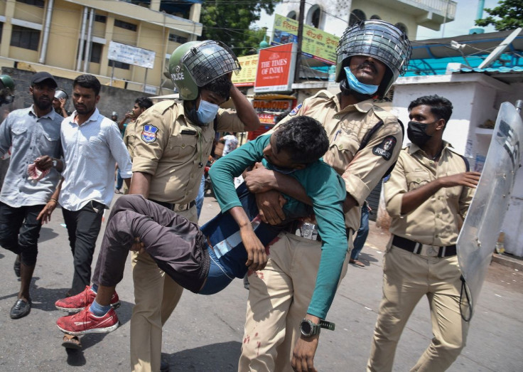 Policemen carry an injured protestor during a protest against "Agnipath scheme" for recruiting personnel for armed forces, in Secunderabad in the southern state of Andhra Pradesh, India, June 17, 2022.