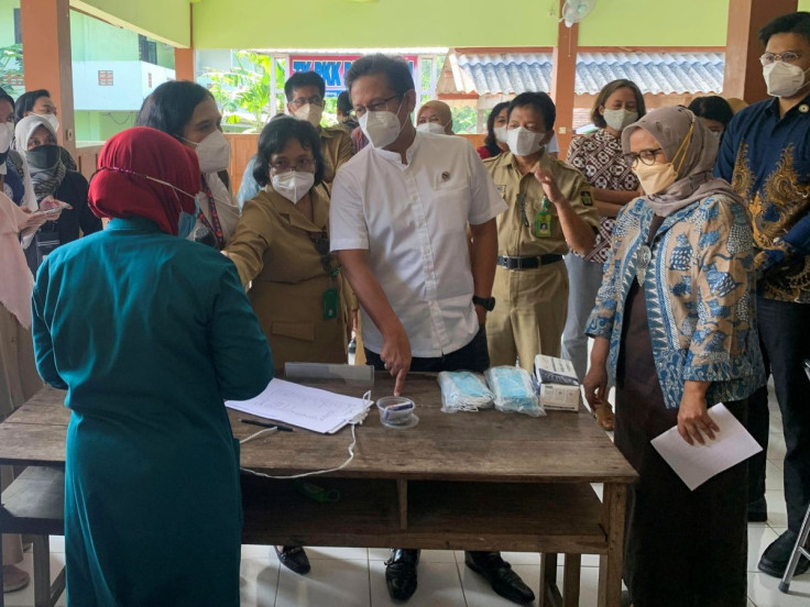 Indonesia's Health Minister Budi Gunadi Sadikin talks to a health official during a tuberculosis screening on the sidelines of the G20 "Health Working Group" event in Yogyakarta, Indonesia, March 29, 2022.