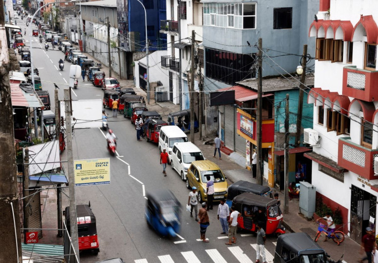 Vehicle owners wait in a queue to buy petrol due to fuel shortage, amid the country's economic crisis, in Colombo, Sri Lanka June 17, 2022. 