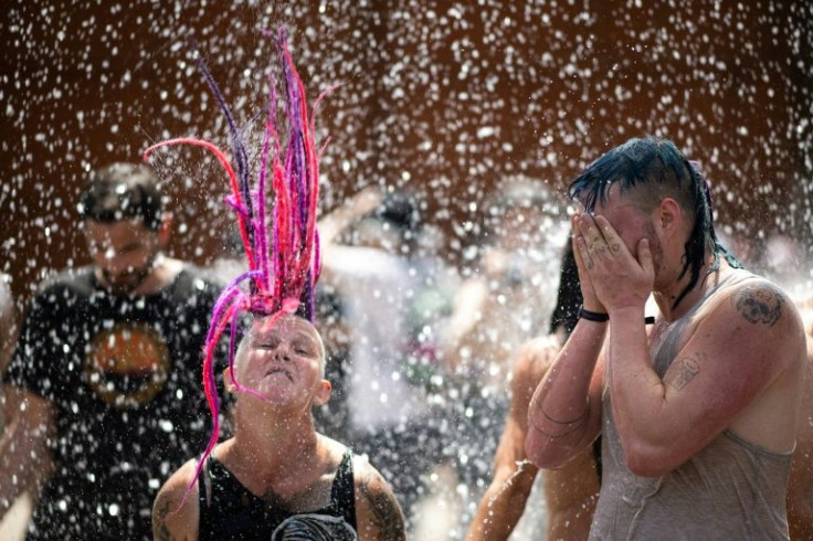 Festival goers at the Hellfest metal music festival in Clisson, western France, were sprayed with water to cool them down