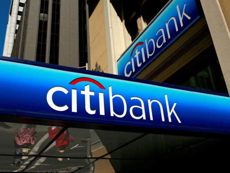 People walk beneath a Citibank branch logo in the financial district of San Francisco, California July 17, 2009.