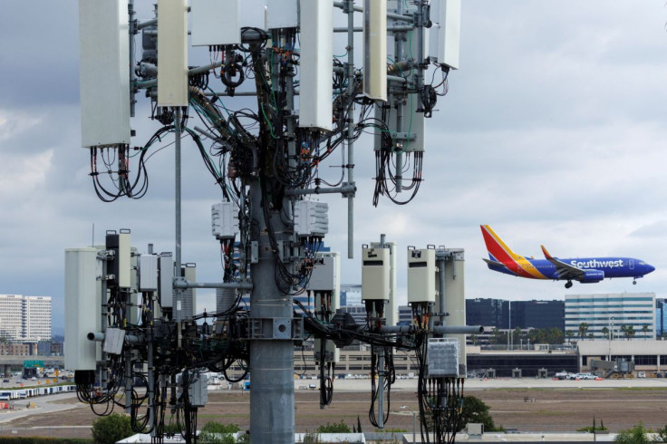 A Southwest commercial aircraft flies past a cell phone tower as it approaches to land at John Wayne Airport in Santa Ana, California U.S. January 18, 2022.  