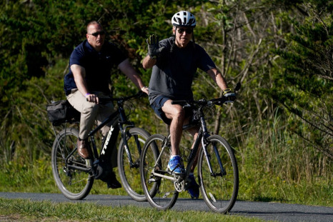U.S. President Joe Biden rides a bike in Rehoboth Beach, Delaware, U.S., June 18, 2022. 