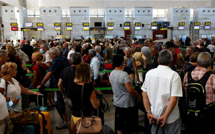 Passengers queue at check-in desks at Malaga-Costa del Sol Airport, in Malaga, Spain June 4, 2022.