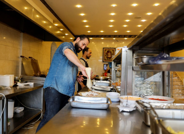 Syrian refugee Anas Qaterji works in his restaurant in Gaza City June 16, 2022. Picture taken June 16, 2022. 