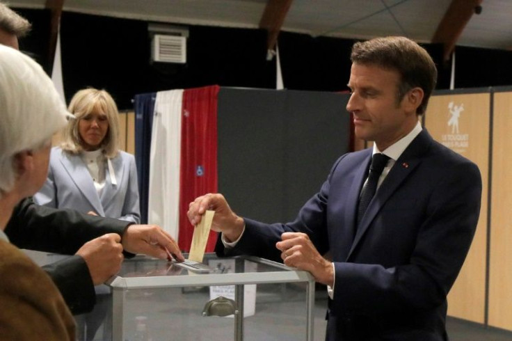 French President Emmanuel Macron (R) voted alongside his wife Brigitte (L) in northern seaside town Le Touquet