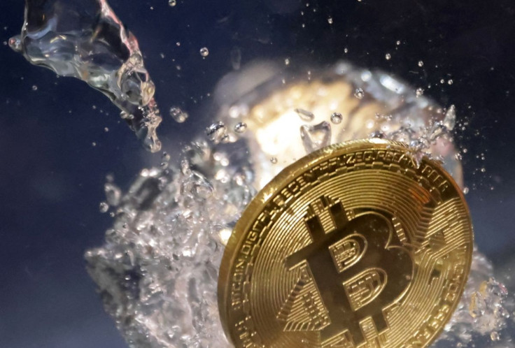 A view of a representation of cryptocurrency Bitcoin plunging into water in this illustration taken, May 23, 2022. 