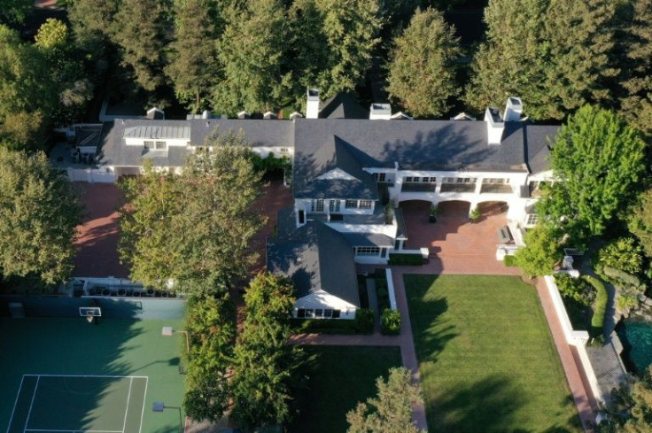 In addition to its 9,000 square-foot floor plan, the property boasts a full-size tennis court, a swimming pool and a pavillion