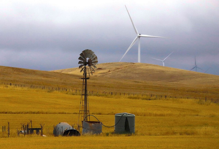 An old windmill stands in front of wind turbines in a paddock near the Hornsdale Power Reserve, featuring the world's largest lithium ion battery made by Tesla, located on the outskirts of the South Australian town of Jamestown, in Australia, December 1,