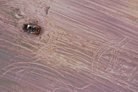 A military vehicle is pictured in a grain field previously mined with explosives, amid the Russian invasion of Ukraine, in Chernihiv region, Ukraine May 24, 2022. Picture taken with drone. 