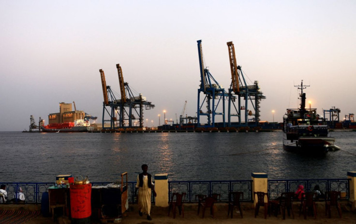 A man stands opposite the modern port at the harbour in Port Sudan at Red Sea State February 24, 2014. 