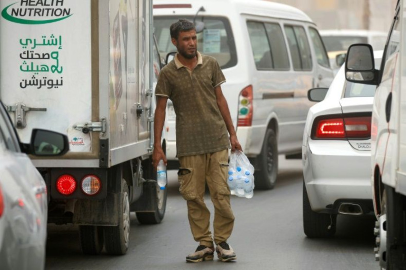 An Iraqi vendor sells water to drivers in the capital Baghdad