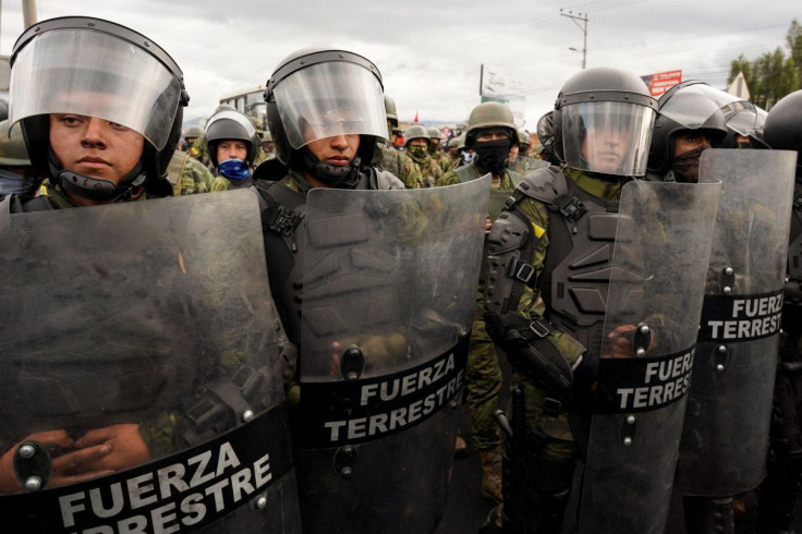 Members of the Ecuadoran military stand guard as indigenous demonstrators march towards the capital Quito after a week of protests against the economic and social policies of President Guillermo Lasso, in Machachi, Ecuador June 20, 2022.