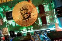 Representation of the virtual currency Bitcoin is seen on a motherboard in this picture illustration taken April 24, 2020. 