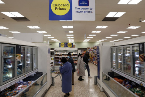 Shoppers walk in a branch of a Tesco supermarket in London, Britain, February 10, 2022. Picture taken February 10, 2022. 