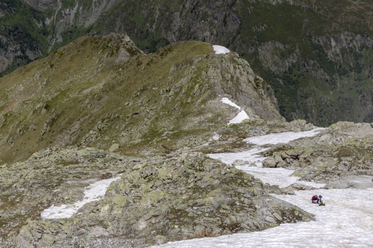 Alberto Amato and Jade Ezzedine of the Cell and Plant Physiology Laboratory of Grenoble take samples of Sanguina nivaloides algae, also known as "snow blood" and which presence accelerates snowmelt, at the Brevent in Chamonix, France, June 14, 2022. Pictu