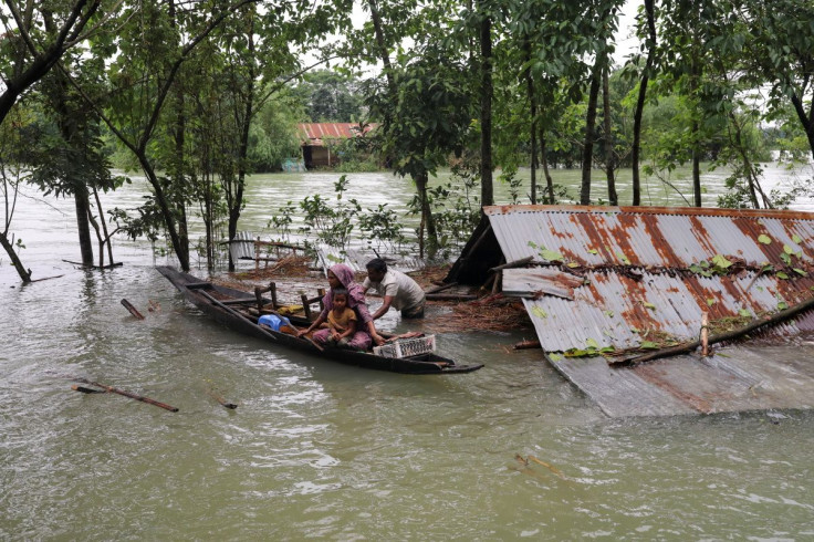 People get on a boat as they look for shelter during a widespread flood in the northeastern part of the country, in Sylhet, Bangladesh, June 19, 2022.