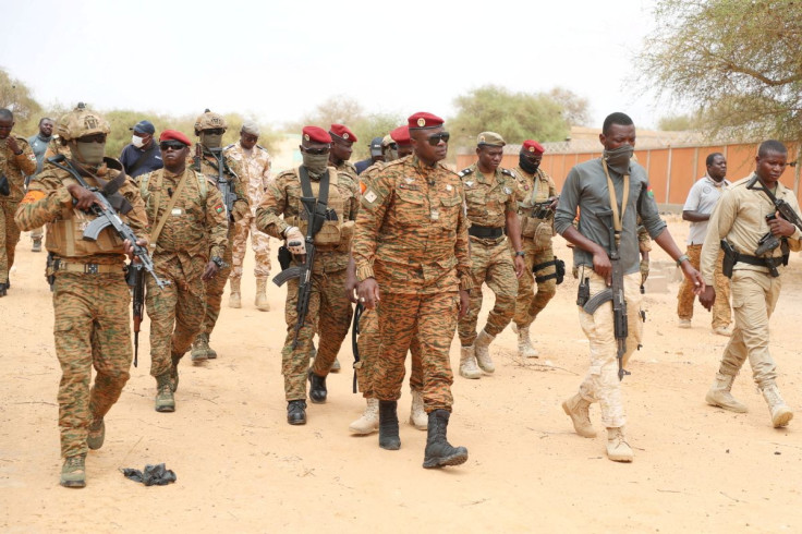Burkina Faso President Lieutenant Colonel Paul-Henri Damiba is surrounded by soldiers, as he arrives to motivate his troops, after armed men killed civilians and militaries over the weekend in Seytenga, at airport in Dori, Burkina Faso June 15, 2022. Bu