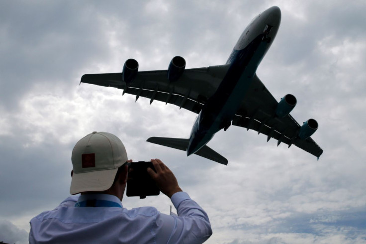 A visitor takes a picture of an Airbus A380 as it lands after an air display at the 53rd International Paris Air Show at Le Bourget Airport near Paris, France June 23, 2019.