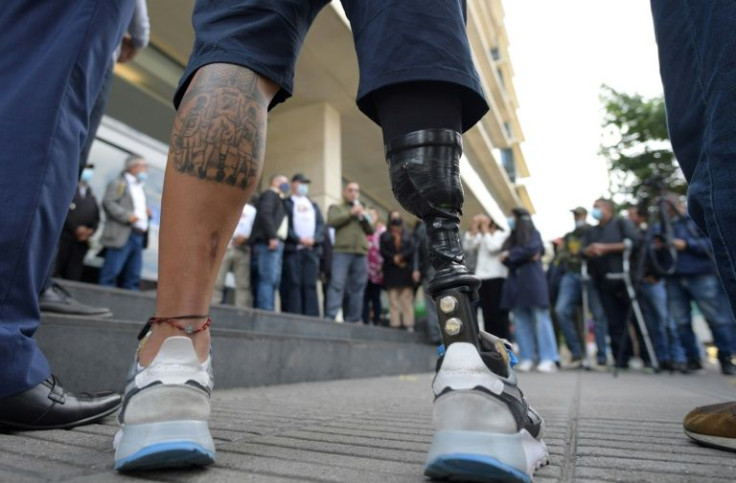 A victim of a landmine wearing a prosthetic leg at an event to commemorate the International Day for Awareness Against Anti-Personnel Mines in Bogota in April 2022 -- the United States will return to a ban on landmines except in Korea