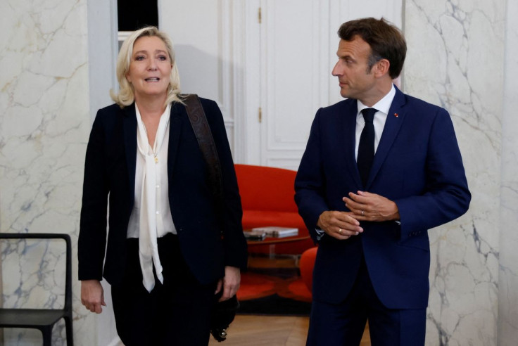 French far-right Rassemblement National (RN) leader and Member of Parliament Marine Le Pen is escorted by France's President Emmanuel Macron after talks at the presidential Elysee Palace, France, June 21, 2022. Ludovic Marin/Pool via REUTERS
