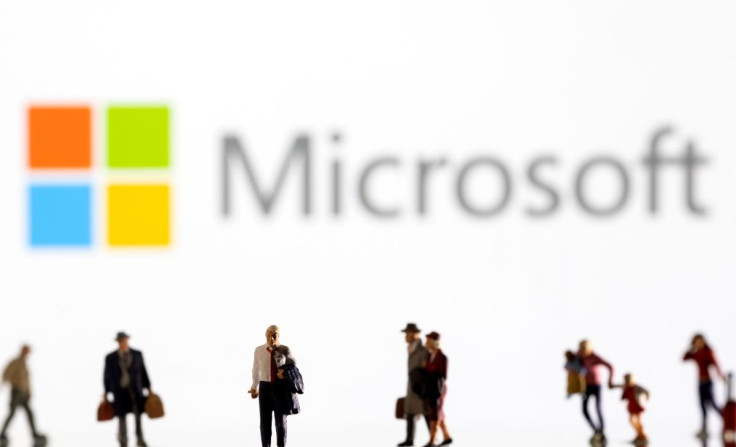 Small figurines are seen in front of displayed Microsoft logo in this illustration taken February 11, 2022. 